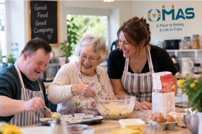Three people of different ages laughing while baking together in the kitchen