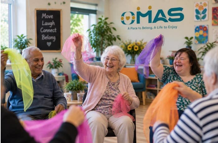 A group laughing and waving colourful scarves during a seated movement session