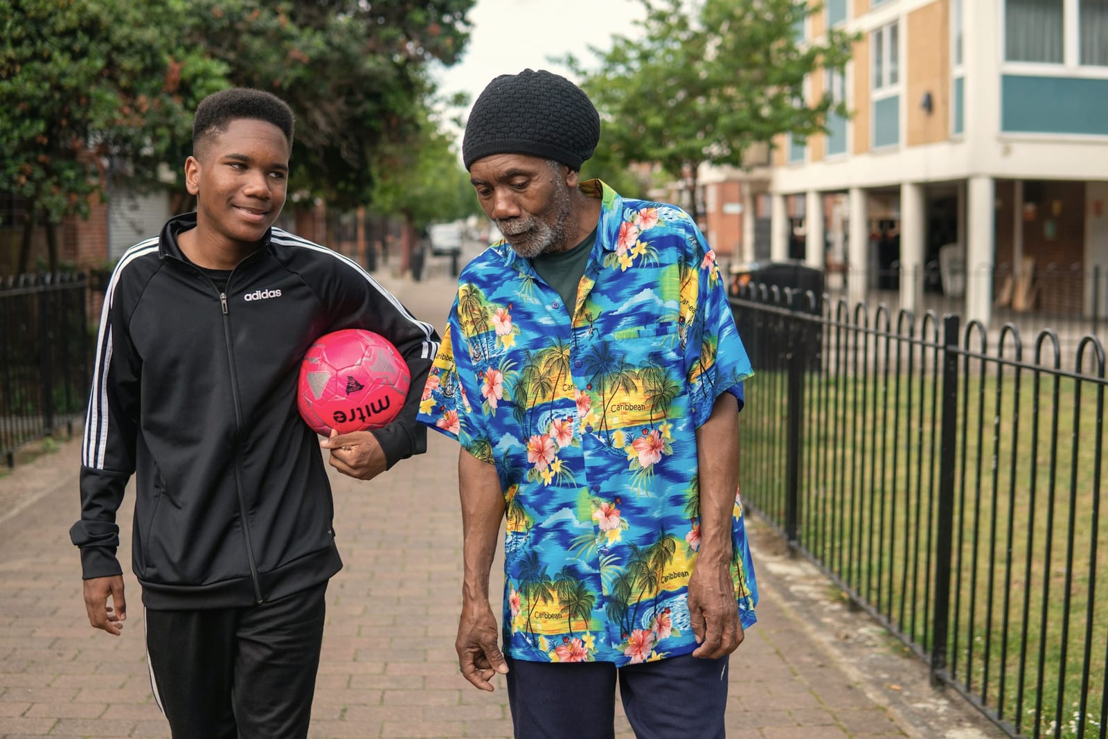 A young man and an older man walking together